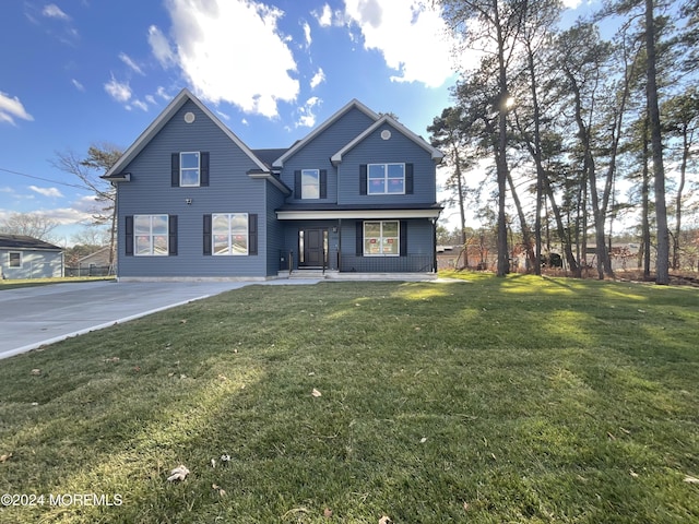 rear view of house featuring a lawn