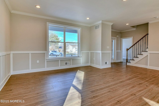 spare room featuring ornamental molding and hardwood / wood-style flooring