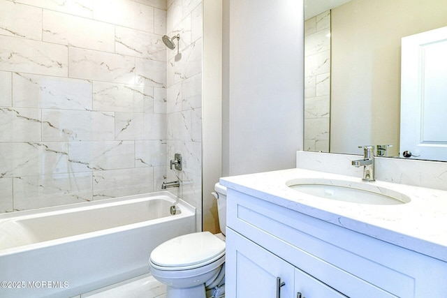 full bathroom with vanity, tiled shower / bath, and toilet