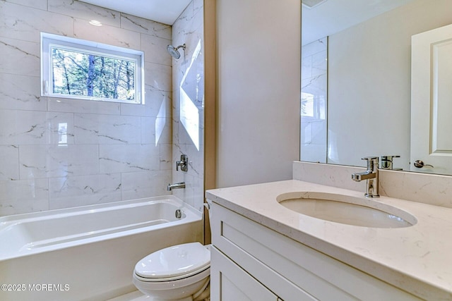 full bathroom featuring vanity, tiled shower / bath, and toilet