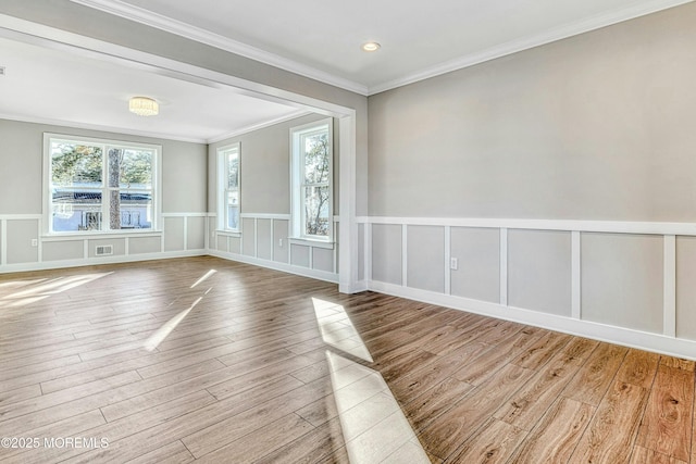 1032 3rd Ave, Toms River, NJ 08757 - unfurnished room with healthy amount of natural light, wood finished floors, a wainscoted wall, crown molding, and a decorative wall