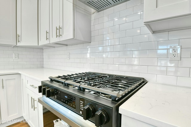 1032 3rd Ave, Toms River, NJ 08757 - kitchen featuring gas range, decorative backsplash, white cabinetry, custom exhaust hood, and light stone countertops