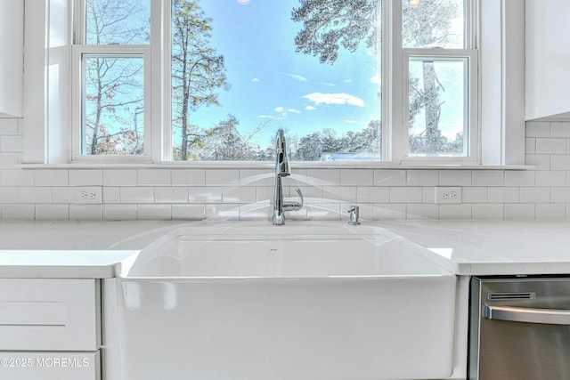 1032 3rd Ave, Toms River, NJ 08757 - kitchen view of dishwasher, white cabinets, and decorative backsplash
