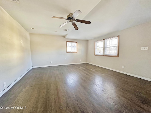 spare room with ceiling fan and dark hardwood / wood-style floors