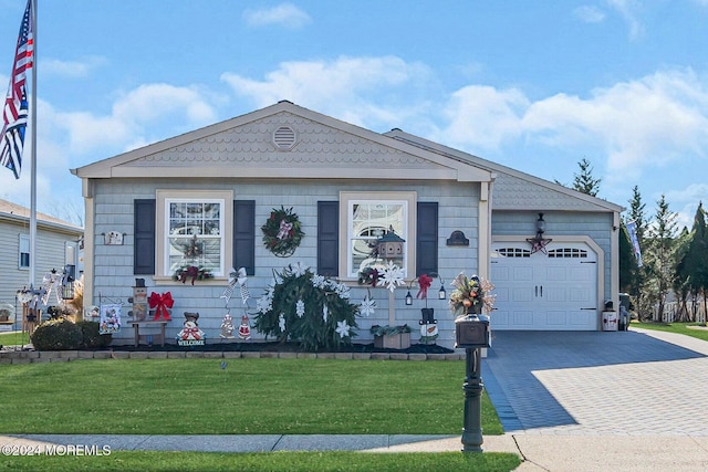 view of front of property featuring a garage and a front lawn