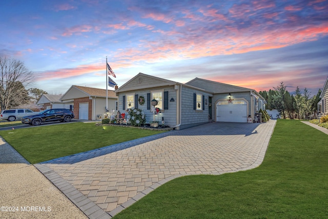 ranch-style house with a garage and a lawn