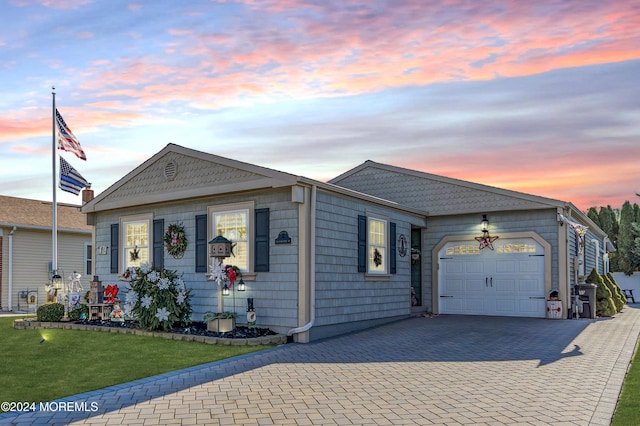 view of front facade with a lawn and a garage