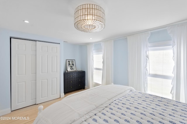 bedroom featuring light wood-type flooring and a closet