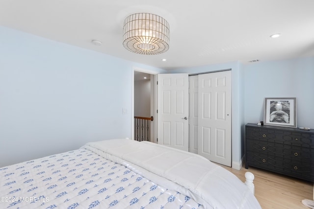 bedroom featuring a closet and light wood-type flooring