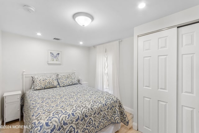 bedroom with wood-type flooring and a closet