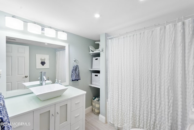 bathroom with vanity and hardwood / wood-style flooring