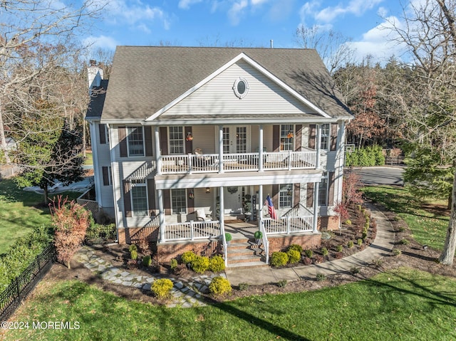 rear view of house featuring a porch