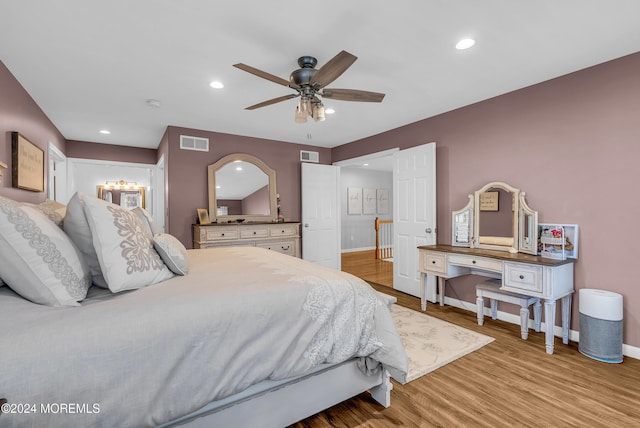 bedroom with ceiling fan and light hardwood / wood-style floors