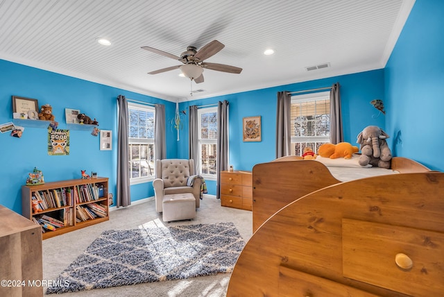 carpeted bedroom with ceiling fan and crown molding