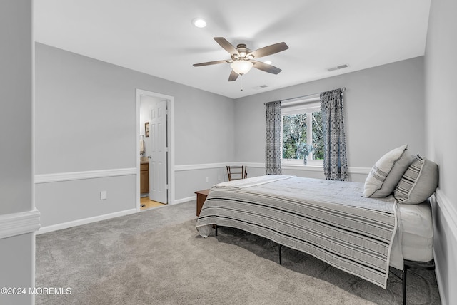 bedroom featuring ceiling fan, carpet floors, and ensuite bathroom