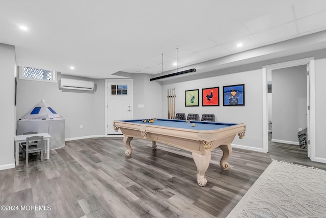 recreation room featuring a wall mounted air conditioner, a drop ceiling, wood-type flooring, and pool table