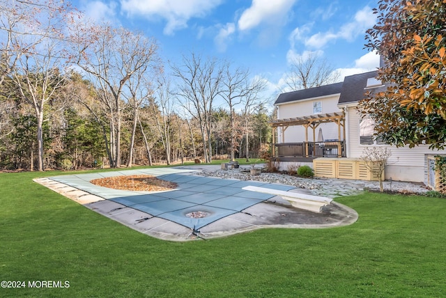 view of pool featuring a lawn, a patio area, a pergola, and a wooden deck