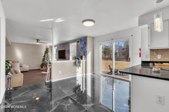 kitchen with white cabinets, pendant lighting, decorative backsplash, and ceiling fan