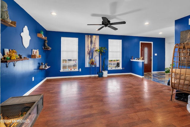 living room with hardwood / wood-style floors, a wealth of natural light, and ceiling fan