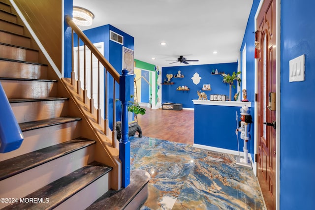 interior space featuring wood-type flooring and ceiling fan