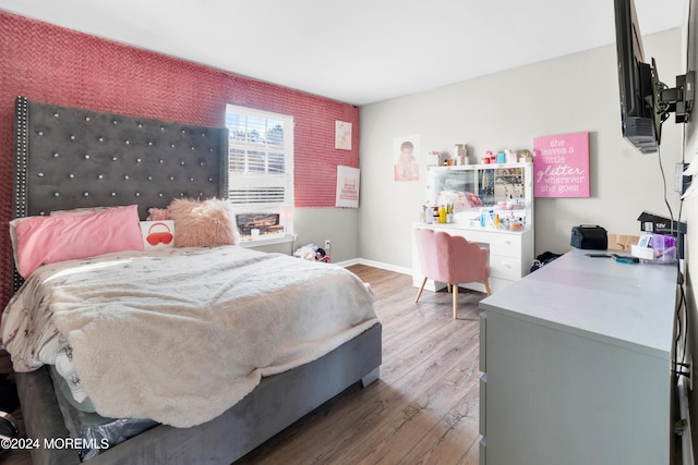 bedroom with hardwood / wood-style floors