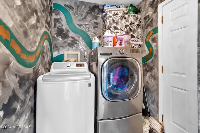 clothes washing area featuring independent washer and dryer