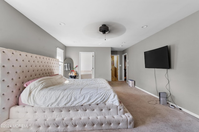 carpeted bedroom featuring connected bathroom and ceiling fan