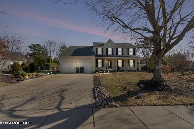 view of front of property with covered porch and a garage