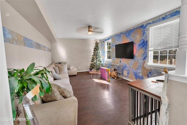 living room featuring dark hardwood / wood-style flooring, a wealth of natural light, and ceiling fan