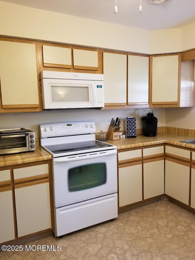 33 Penwood Dr Unit 55, Whiting, NJ 08759 - kitchen with white appliances, light countertops, light floors, and a sink