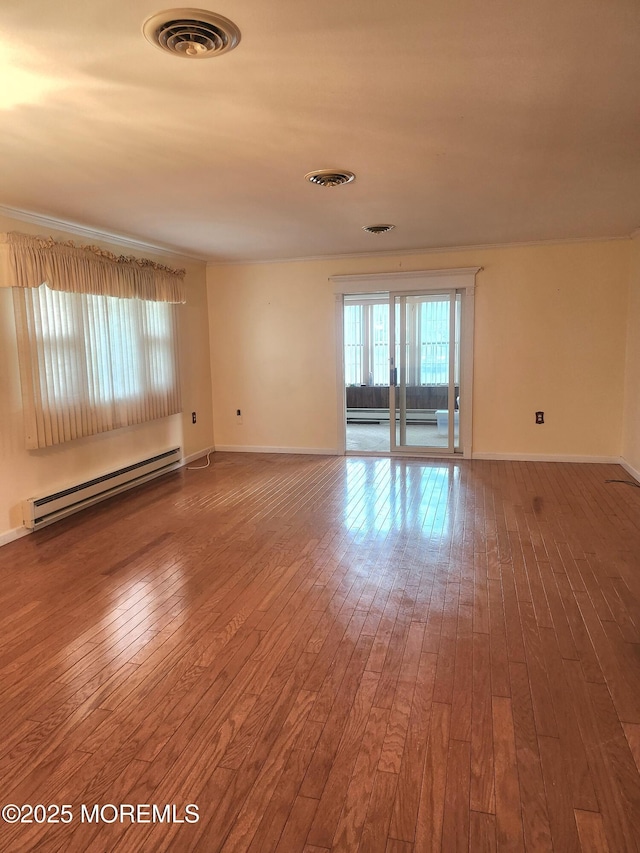 33 Penwood Dr Unit 55, Whiting, NJ 08759 - spare room with baseboard heating, hardwood / wood-style flooring, and baseboards