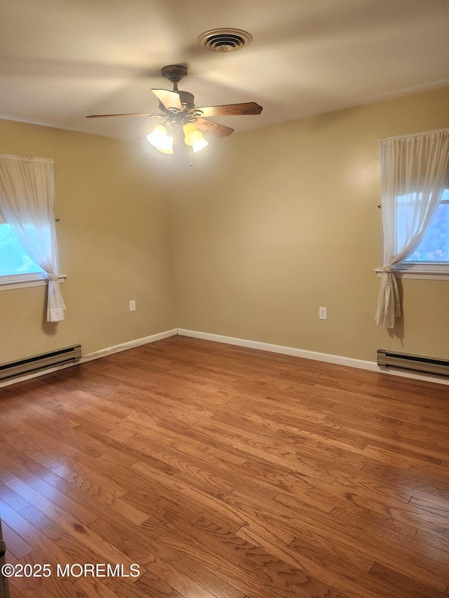 33 Penwood Dr Unit 55, Whiting, NJ 08759 - unfurnished room with hardwood / wood-style floors, a baseboard heating unit, a ceiling fan, and baseboards