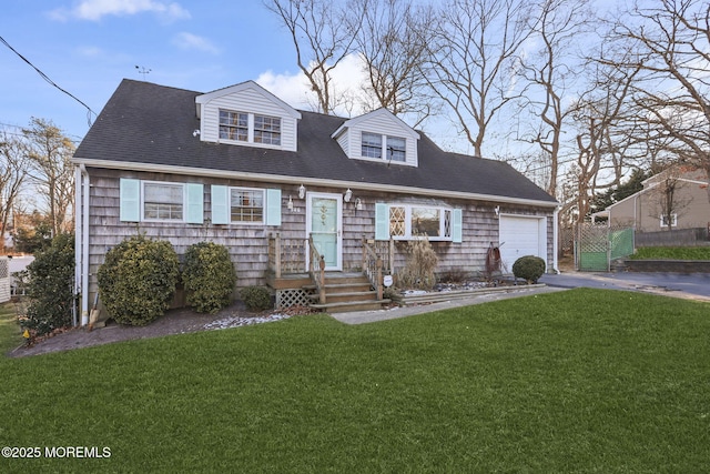 cape cod house featuring a garage and a front lawn