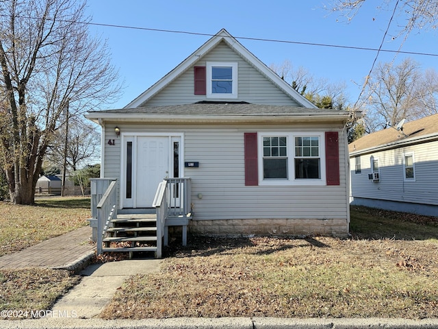 bungalow-style home featuring a front yard