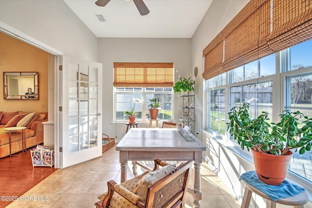 sunroom / solarium with ceiling fan and visible vents