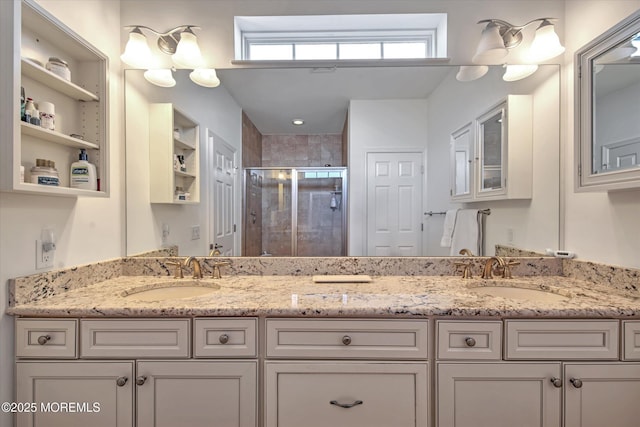 full bath featuring a sink, a shower stall, and double vanity