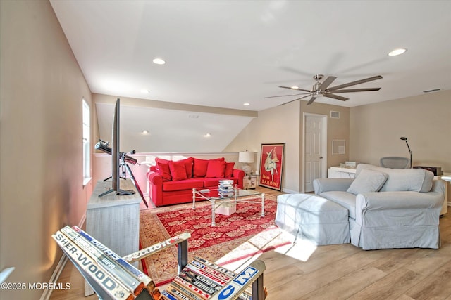 living room with light wood-style flooring, visible vents, baseboards, and recessed lighting