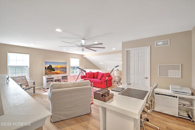 living room featuring light wood-type flooring, a wealth of natural light, visible vents, and recessed lighting