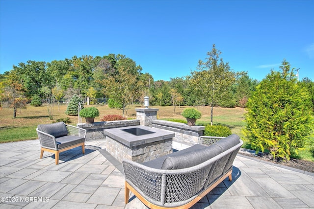 view of patio / terrace featuring an outdoor fire pit