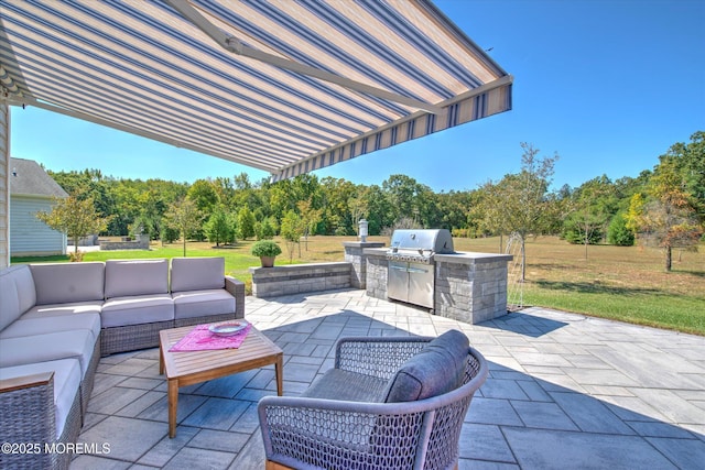 view of patio / terrace with an outdoor hangout area, an outdoor kitchen, and a grill