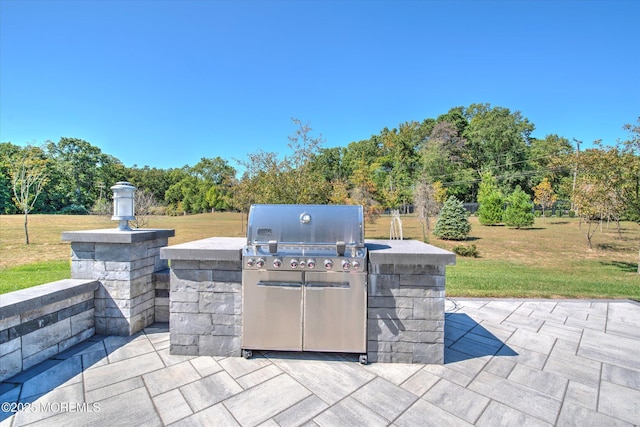 view of patio with a grill and an outdoor kitchen