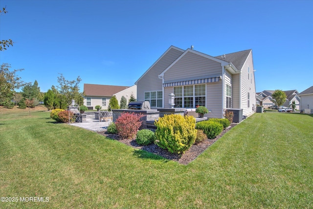 rear view of property with a patio area and a lawn