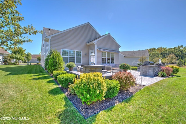 rear view of house with a yard, outdoor lounge area, and a patio