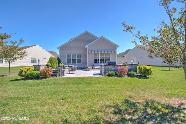 rear view of property featuring a lawn and a patio