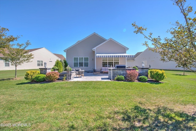 rear view of property with a yard and a patio