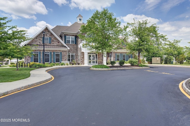 view of front of property with stone siding and french doors