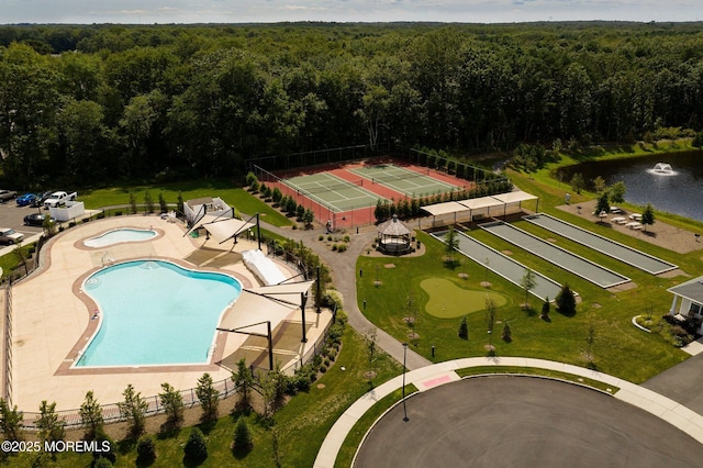 birds eye view of property with a forest view and a water view