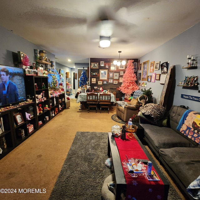 living room with carpet and a notable chandelier