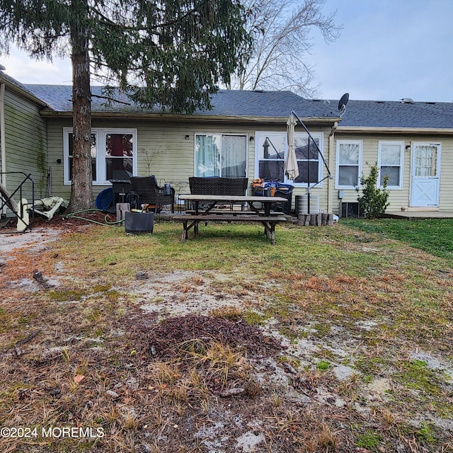 rear view of house with a yard