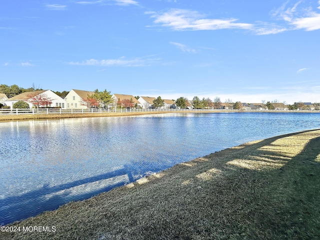 property view of water featuring a residential view and fence